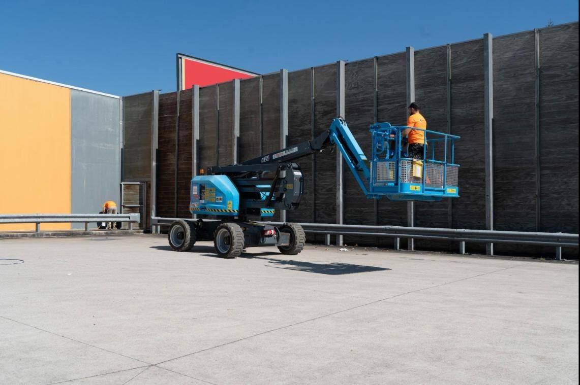 Boom lift at a retail wall